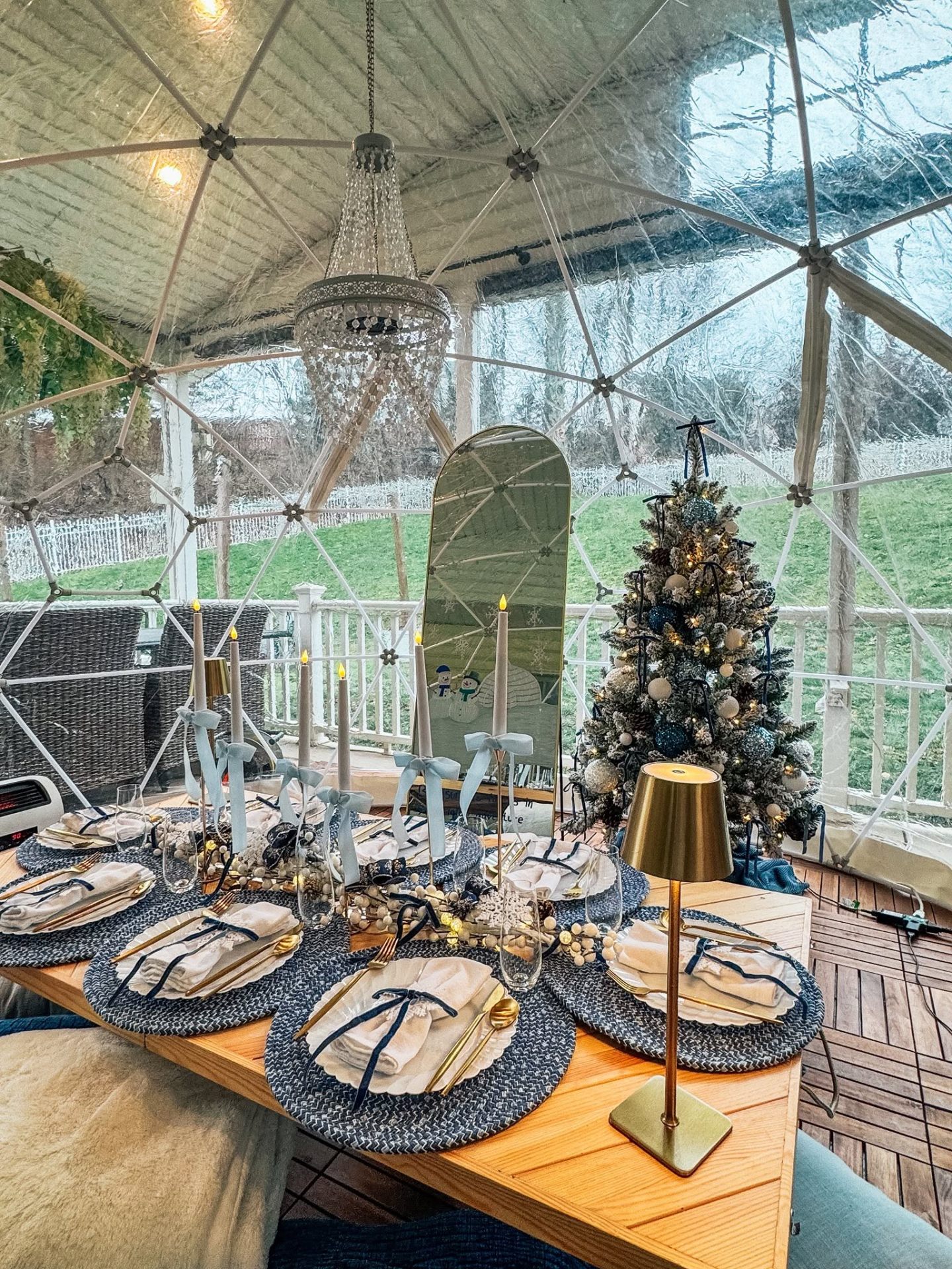 Winter wonderland blue and white igloo tablescape with chandelier and flocked tree
