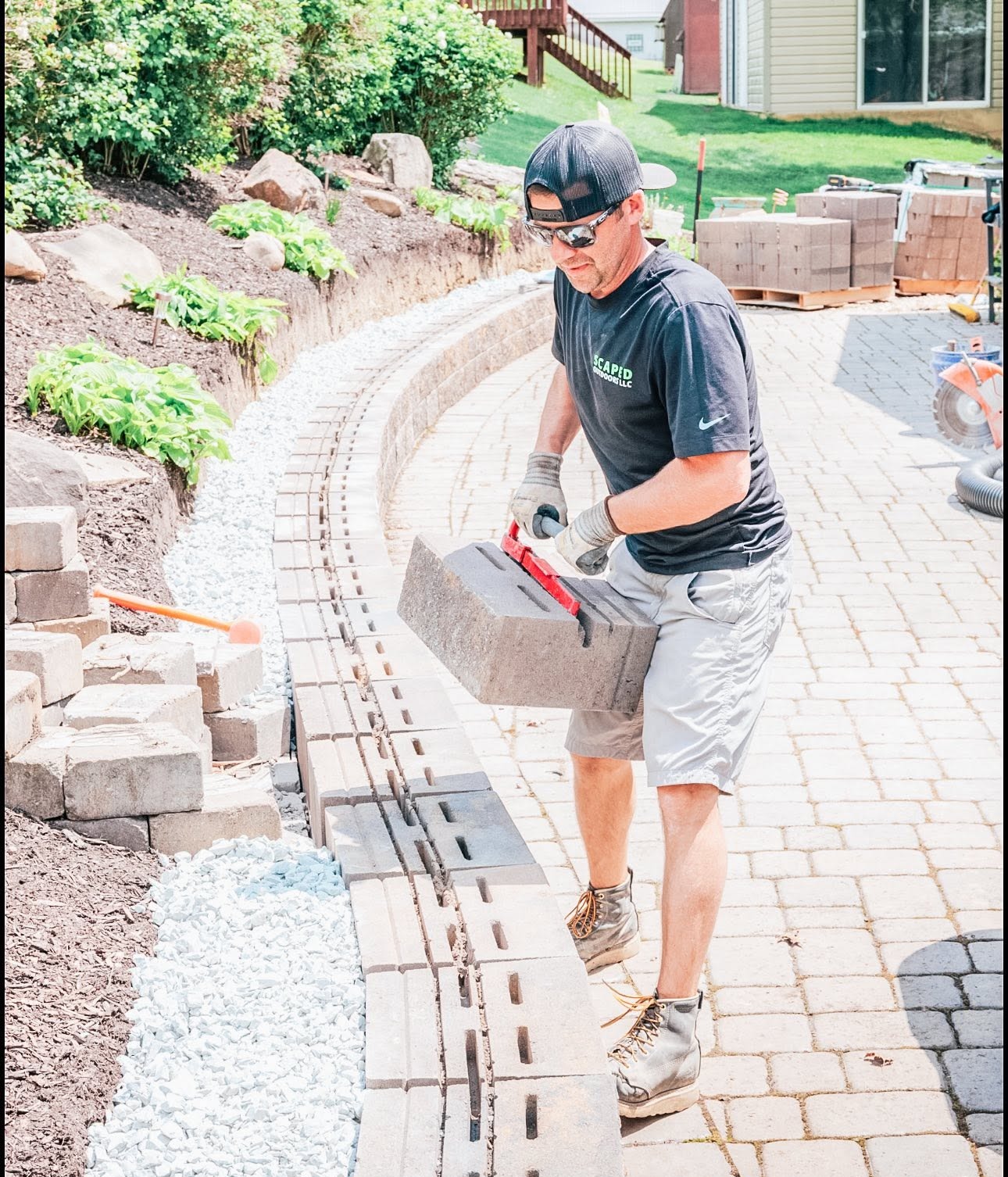 Kevin Griffith installing hardscape block on a paver patio project