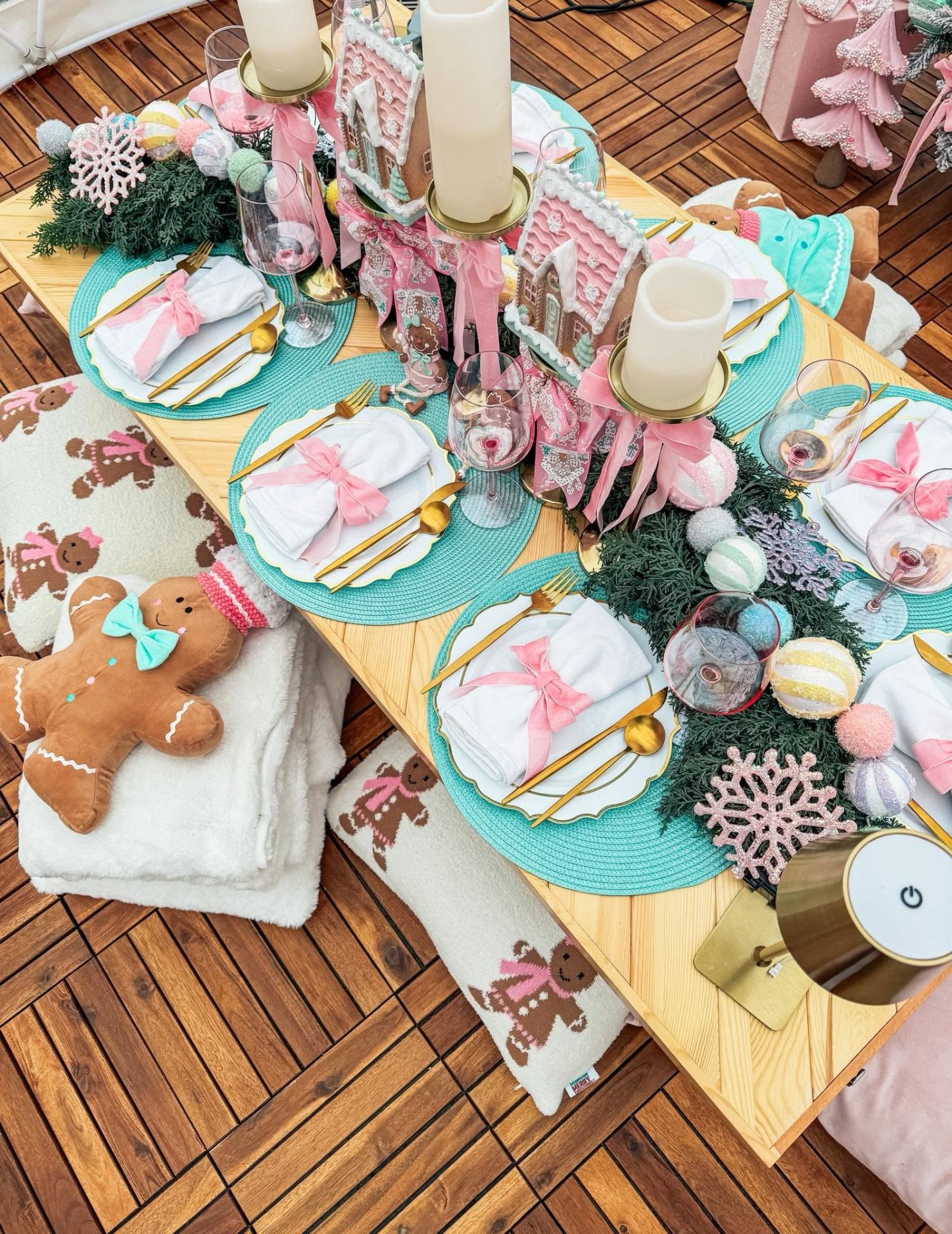 Pastel pink and teal gingerbread themed igloo tablescape with gold flatware