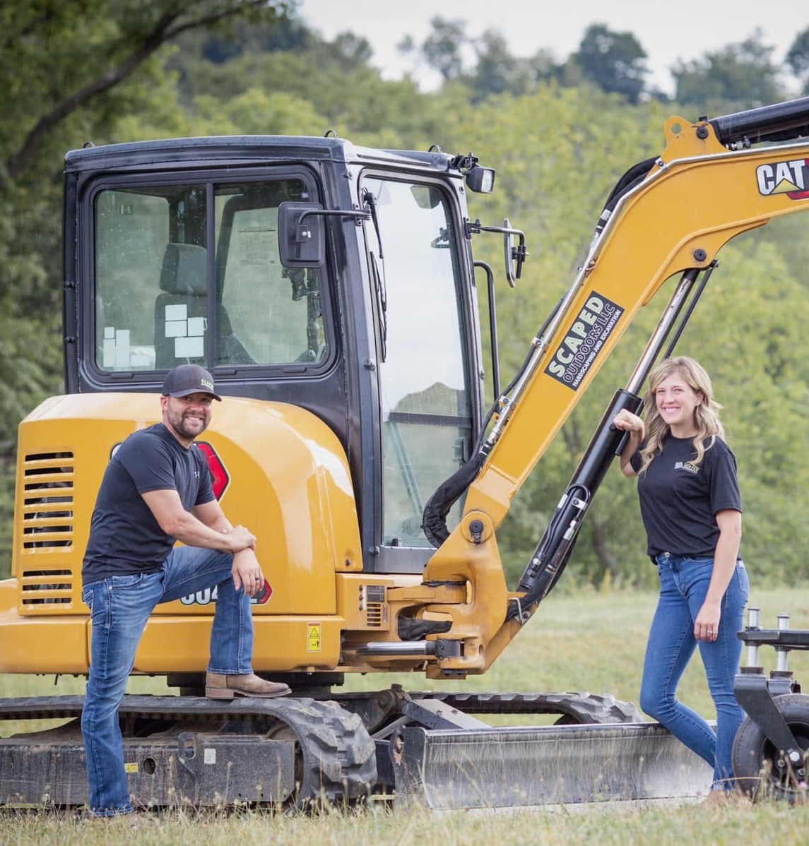 Scaped Outdoors owners with CAT mini excavator serving Western Pennsylvania properties